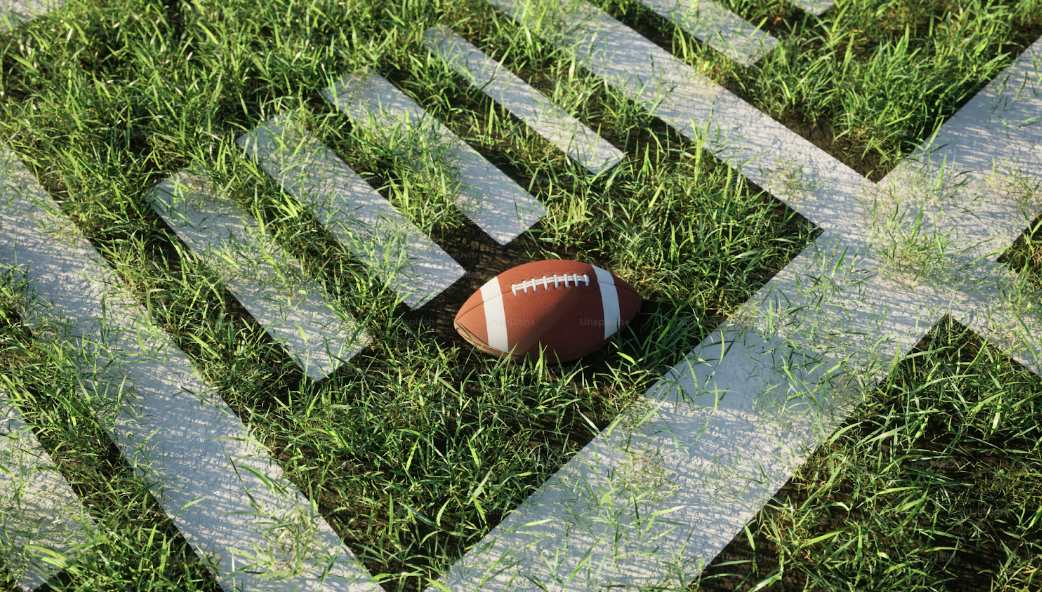 This photo shows a spotlight on the football field, by Alexander Mils, Unsplash.

